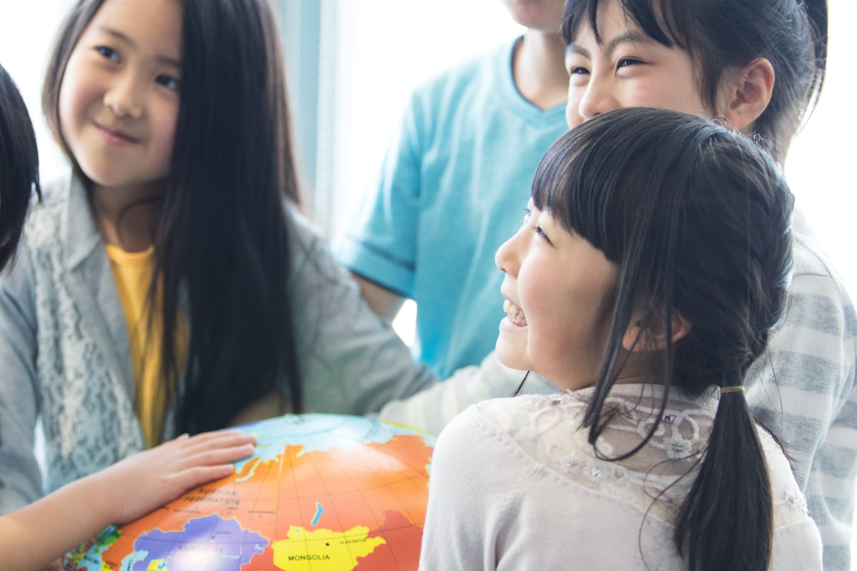 Elementary school students with globe