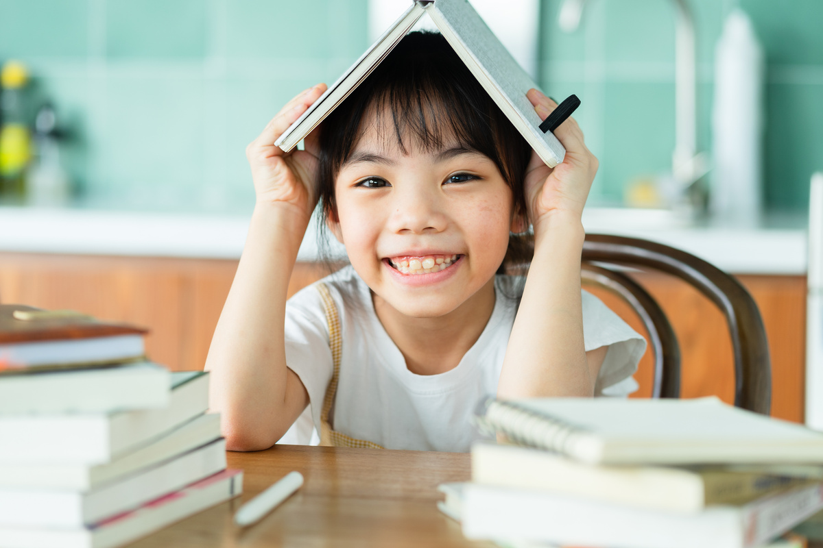 Asian Child Studying at Home
